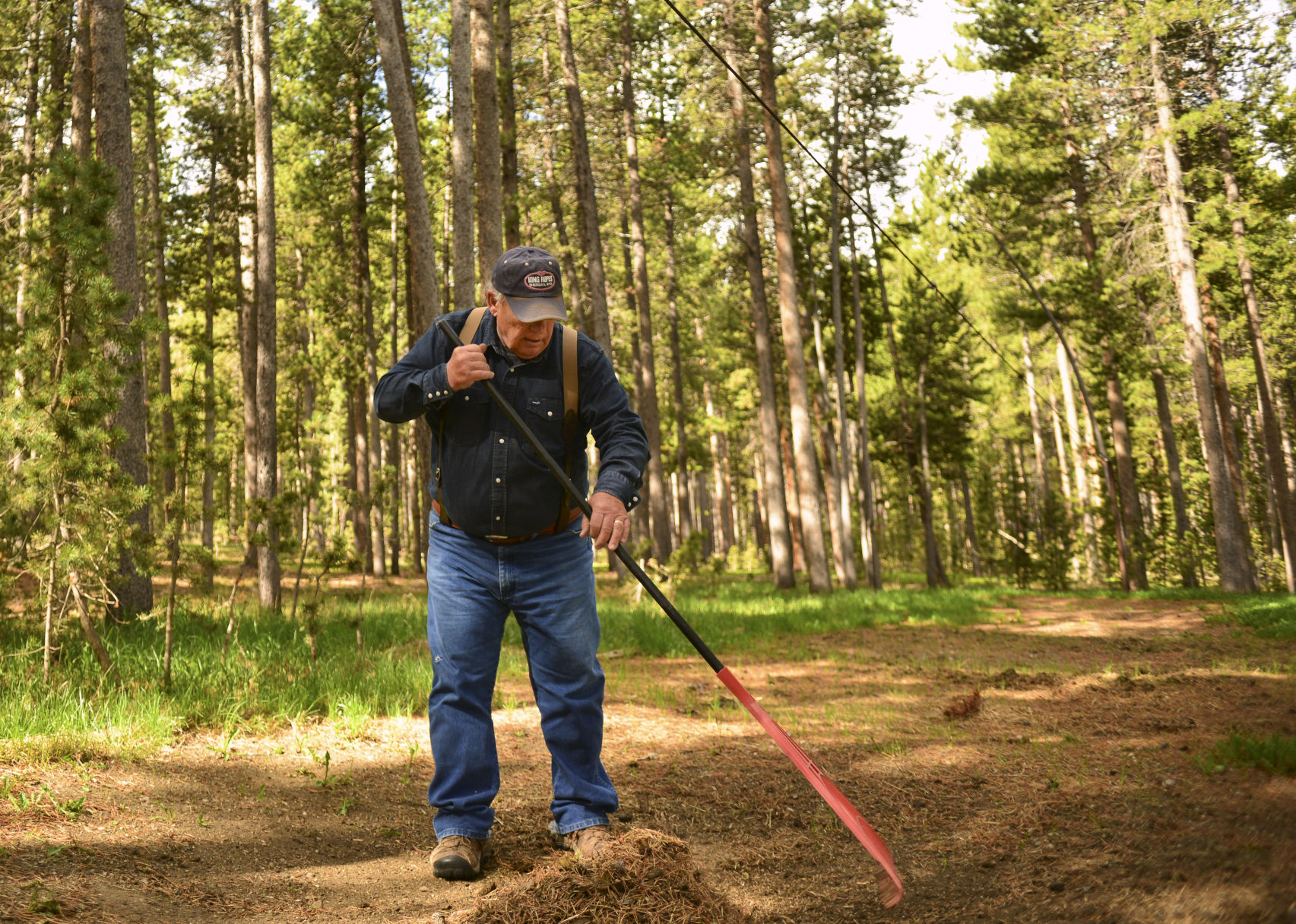 Kent Ruesch rakes up old manure and dirt